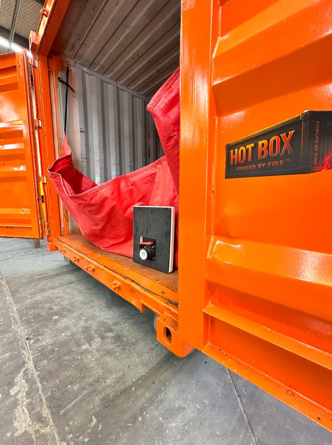 HOT BOX container open in shop — red bladder system visible inside